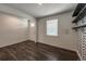 Bright living room with unique accent wall and dark, modern floors at 2325 Mountain Sky Dr, Fort Lupton, CO 80621