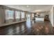 Spacious living room featuring large windows, hardwood floors, and an open concept design at 2325 Mountain Sky Dr, Fort Lupton, CO 80621