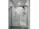Modern bathroom shower with clear glass door, handheld shower head, and tiled walls at 2325 Mountain Sky Dr, Fort Lupton, CO 80621