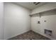 The utility room features tile flooring, a shelf, and access points for appliances at 2325 Mountain Sky Dr, Fort Lupton, CO 80621