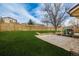 Spacious backyard with well-kept lawn and a decorative rock area, perfect for relaxation and recreation at 16397 E Wyoming Dr, Aurora, CO 80017