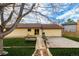 A peaceful backyard with a stone path to a deck, complemented by lush grass and a privacy fence at 16397 E Wyoming Dr, Aurora, CO 80017