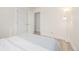Simple bedroom featuring wood-look flooring and access to ensuite bath at 16397 E Wyoming Dr, Aurora, CO 80017