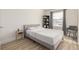 Well-lit bedroom showcasing stylish decor, wood floors, and modern gray decor at 16397 E Wyoming Dr, Aurora, CO 80017