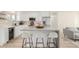Modern kitchen featuring an island with seating, stainless steel appliances, and bright white cabinets at 16397 E Wyoming Dr, Aurora, CO 80017