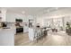 Bright modern kitchen features an island with bar seating, stainless steel appliances, and ample counter space at 16397 E Wyoming Dr, Aurora, CO 80017