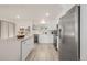 Bright modern kitchen features an island with bar seating, stainless steel appliances, and ample counter space at 16397 E Wyoming Dr, Aurora, CO 80017