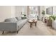 Bright living room featuring modern furniture, a neutral color scheme, and stylish flooring at 16397 E Wyoming Dr, Aurora, CO 80017