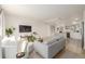 Open-concept living room with kitchen view, featuring modern furnishings and stylish flooring at 16397 E Wyoming Dr, Aurora, CO 80017