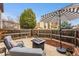Private backyard patio with comfortable seating, umbrella, and a fire pit at 7250 Eastmoor Dr # 119, Denver, CO 80237