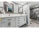 Modern bathroom with double vanity, updated fixtures, and a glass-enclosed shower for a spa-like experience at 7250 Eastmoor Dr # 119, Denver, CO 80237