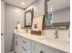Modern bathroom featuring double sinks, white cabinetry, updated mirrors, and decor at 7250 Eastmoor Dr # 119, Denver, CO 80237