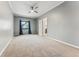 Neutral bedroom features neutral carpet, ceiling fan, window with curtains, and ensuite access at 7250 Eastmoor Dr # 119, Denver, CO 80237