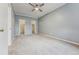 Spacious bedroom with neutral carpet, ceiling fan, and walk-in closets at 7250 Eastmoor Dr # 119, Denver, CO 80237