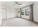Bright bedroom with neutral carpet, two windows, and closet at 7250 Eastmoor Dr # 119, Denver, CO 80237