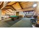 An expansive billiards room features a pool table, lounge seating, and wood-paneled decor at 7250 Eastmoor Dr # 119, Denver, CO 80237