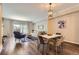 Open floor plan with dining area featuring modern light fixture, table, and chairs at 7250 Eastmoor Dr # 119, Denver, CO 80237