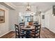 Cozy dining area adjacent to kitchen, featuring wooden table set for four, and modern lighting at 7250 Eastmoor Dr # 119, Denver, CO 80237