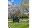 Scenic view of Eastmoor Park featuring lush green grass, walking path, and a park sign at 7250 Eastmoor Dr # 119, Denver, CO 80237