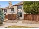 Charming home featuring a fenced yard, stone facade, and mature trees for added privacy and curb appeal at 7250 Eastmoor Dr # 119, Denver, CO 80237