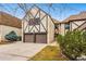 Charming townhome featuring a stone and brick facade, two-car garage, and well-maintained landscaping at 7250 Eastmoor Dr # 119, Denver, CO 80237