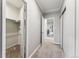 Bright hallway with neutral walls and carpet, closet, and view to rooms beyond at 7250 Eastmoor Dr # 119, Denver, CO 80237