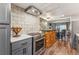 Updated kitchen with stainless steel appliances, island, and open view to the dining area at 7250 Eastmoor Dr # 119, Denver, CO 80237