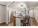 Modern kitchen features stainless steel appliances, white cabinets, and a breakfast bar with seating at 7250 Eastmoor Dr # 119, Denver, CO 80237