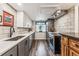 Well-lit kitchen boasting white cabinets, sleek countertops, and stainless steel appliances at 7250 Eastmoor Dr # 119, Denver, CO 80237