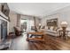 Bright living room with wood floors, a fireplace, comfortable seating, and natural light at 7250 Eastmoor Dr # 119, Denver, CO 80237