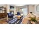 Bright living room with a fireplace, blue chairs, and a sliding glass door to an outdoor space at 7250 Eastmoor Dr # 119, Denver, CO 80237