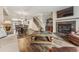 Inviting living room featuring wood floors, a fireplace, and an open floor plan with dining area at 7250 Eastmoor Dr # 119, Denver, CO 80237