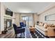Bright living room boasts a fireplace, hardwood floors, and sliding glass doors to the patio at 7250 Eastmoor Dr # 119, Denver, CO 80237