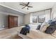 Bedroom featuring a ceiling fan, two windows, a closet and carpet flooring at 7250 Eastmoor Dr # 119, Denver, CO 80237