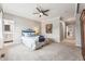 Serene bedroom with ceiling fan, plush carpeting, calming colors, and access to ensuite bathroom at 7250 Eastmoor Dr # 119, Denver, CO 80237