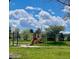 Vibrant playground area with slides and climbing structures, nestled in a picturesque park setting at 7250 Eastmoor Dr # 119, Denver, CO 80237