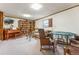 A cozy recreation room includes a piano, seating area, and game table for relaxation at 7250 Eastmoor Dr # 119, Denver, CO 80237