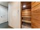 A bright, paneled wood sauna room featuring a built in wood bench, and is adjacent to the hall at 7250 Eastmoor Dr # 119, Denver, CO 80237