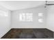 Bright, minimalist bedroom with hardwood floors and ample natural light from multiple windows at 3635 Osage St, Denver, CO 80211
