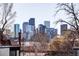 Rooftop view of the city skyline, framed by tree branches at 3635 Osage St, Denver, CO 80211