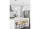 Bright kitchen features a large center island with stylish seating and pendant lighting at 3635 Osage St, Denver, CO 80211