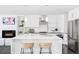 Modern kitchen featuring a large center island, stainless steel appliances, and sleek white cabinets at 3635 Osage St, Denver, CO 80211