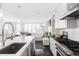 Open concept kitchen showcases stainless steel appliances and seamless transition to living area at 3635 Osage St, Denver, CO 80211