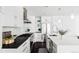 Gourmet kitchen featuring stainless steel appliances, white cabinetry, and a spacious island at 3635 Osage St, Denver, CO 80211