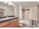 Bathroom featuring a shower and bathtub with an updated vanity and a decorative white shelving unit at 1623 Saint Paul St # 306, Denver, CO 80206