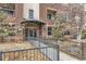 Welcoming entrance of a brick building featuring well-kept landscaping and accessible ramp at 1623 Saint Paul St # 306, Denver, CO 80206