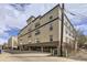 Modern apartment building featuring a neutral color scheme and open parking at 1623 Saint Paul St # 306, Denver, CO 80206