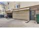 A garage with a roll-up door and a car parked inside at 1623 Saint Paul St # 306, Denver, CO 80206