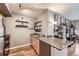 Kitchen with granite countertop, stainless steel appliances, and open shelving at 1623 Saint Paul St # 306, Denver, CO 80206