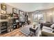 Cozy living room with stylish décor and large windows that let in light, hardwood floors, and view to a balcony at 1623 Saint Paul St # 306, Denver, CO 80206